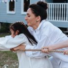 Family enjoying a playful tug of war game outdoors, showcasing teamwork and fun.
